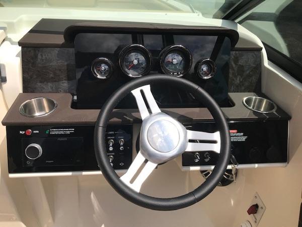 Slide: The Image of 2025 Sea Ray SDX 250 dashboard with steering wheel and gauges. - 15