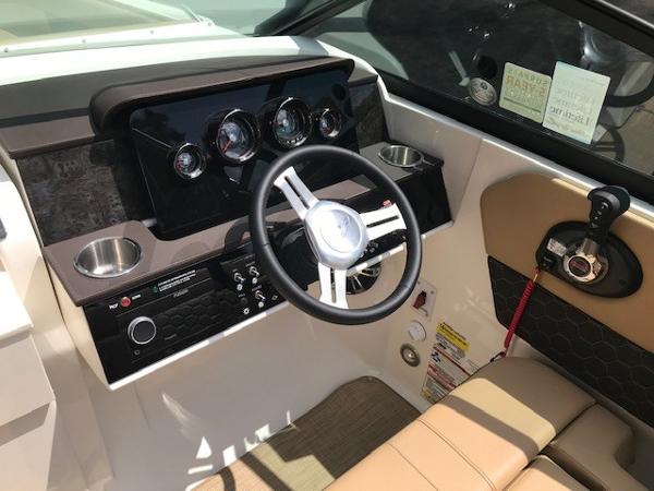 Slide: The Image of 2025 Sea Ray SDX 250 boat dashboard with steering wheel and control panel. - 16