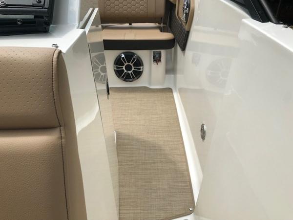 Slide: The Image of 2025 Sea Ray SDX 250 interior with beige seating and speaker system. - 23