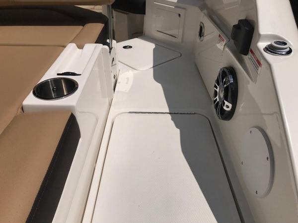 Slide: The Image of 2025 Sea Ray SDX 250 boat interior with seating, cup holder, and speaker. - 9