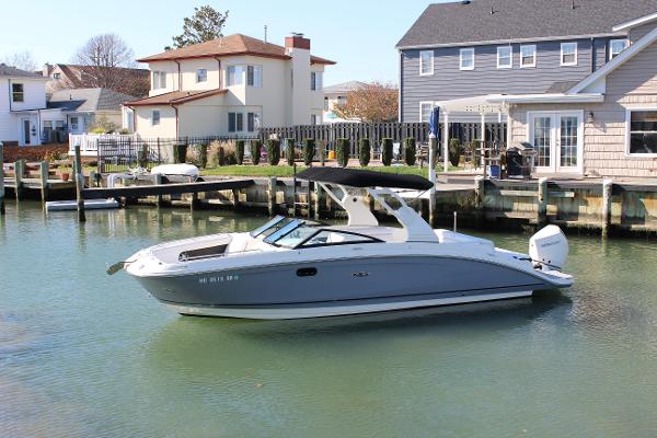 Slide: The Image of 2020 Sea Ray SDX 270 OB boat docked in a residential canal. - 1