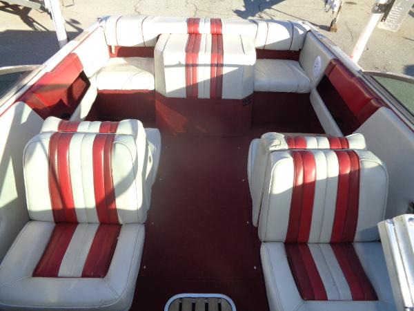 Slide: The Image of 1988 Sea Ray Seville 20 Bow Rider interior with red and white striped seats. - 0