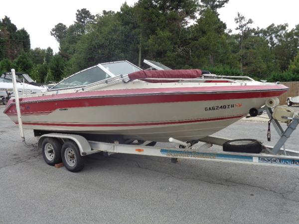Slide: The Image of 1988 Sea Ray Seville 20 Bow Rider on a trailer in a parking lot. - 1