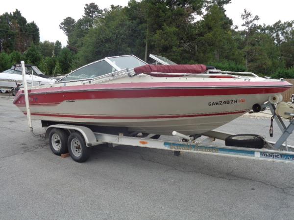 Slide: The Image of 1988 Sea Ray Seville 20 Bow Rider on a trailer in a parking lot. - 11