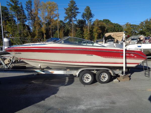 Slide: The Image of 1988 Sea Ray Seville 20 Bow Rider on a trailer, red and white, side view. - 20
