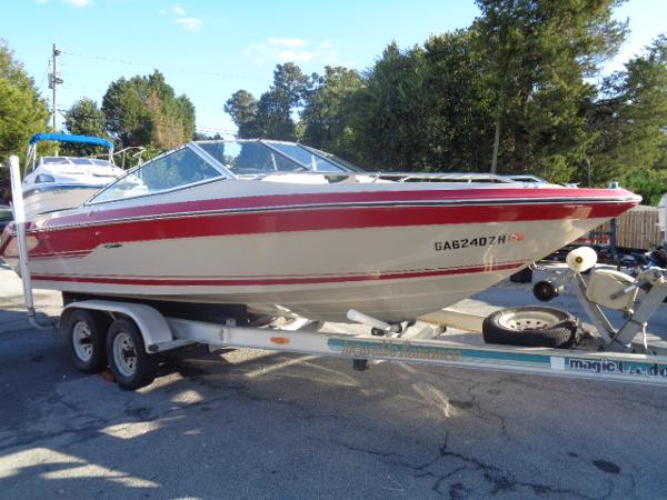 Slide: The Image of 1988 Sea Ray Seville 20 Bow Rider on a trailer, red and white. - 23