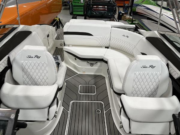 Slide: The Image of 2024 Sea Ray SLX 260 boat interior with white leather seating and diamond stitching. - 74