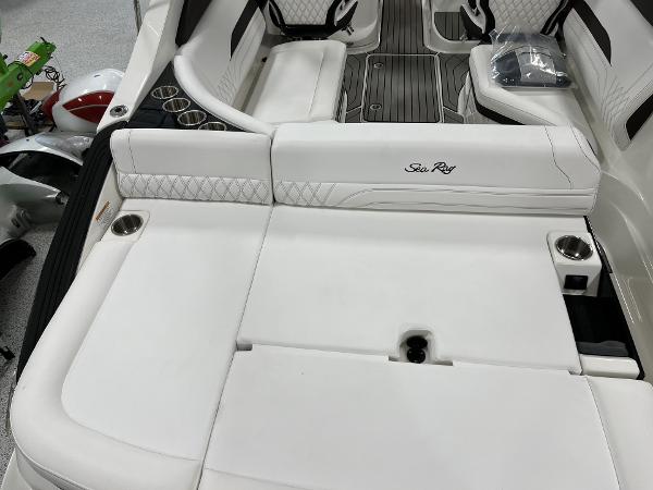 Slide: The Image of 2024 Sea Ray SLX 260 boat interior with white leather seating and cup holders. - 75