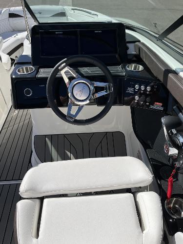 Slide: The Image of 2024 Sea Ray SLX 260 boat cockpit with modern steering wheel and dashboard. - 86