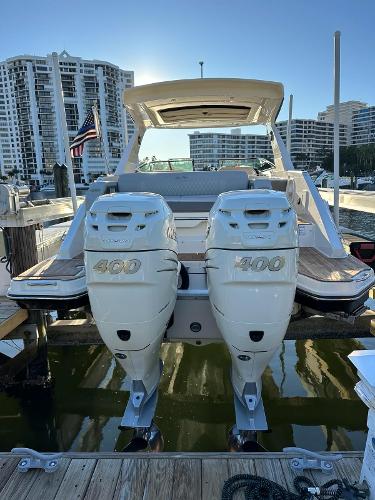 Slide: The Image of 2021 Sea Ray SLX 310 OB with twin 400 horsepower outboard engines docked at marina. - 5
