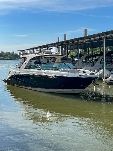 Slide: The Image of 2023 Sea Ray SLX 400 OB luxury boat docked on a sunny day. - 1