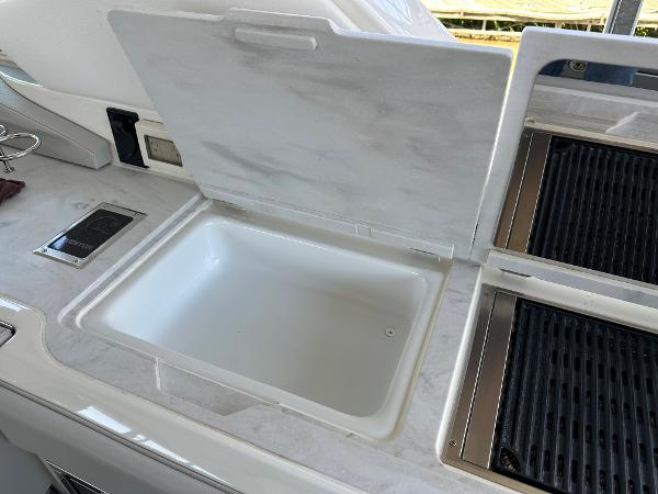 Slide: The Image of 2023 Sea Ray SLX 400 OB yacht kitchen sink and grill area - 10