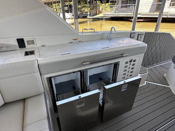 Slide: The Image of 2023 Sea Ray SLX 400 OB yacht with dual stainless steel refrigerators. - 12