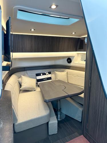 Slide: The Image of Interior of 2023 Sea Ray SLX 400 OB with modern seating and table. - 15