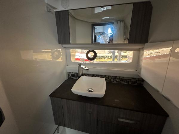 Slide: The Image of Modern bathroom interior of 2023 Sea Ray SLX 400 OB boat with sink and mirror. - 19