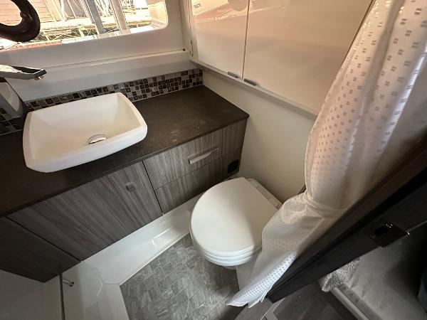 Slide: The Image of Modern bathroom in 2023 Sea Ray SLX 400 OB boat with sink, toilet, and shower. - 20