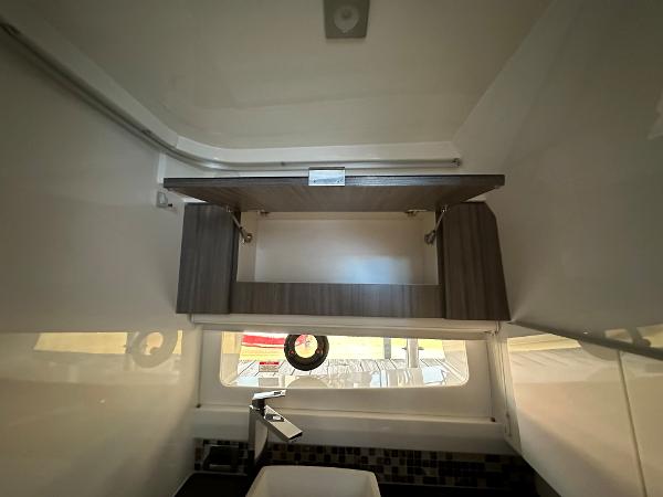 Slide: The Image of Interior of 2023 Sea Ray SLX 400 OB with modern cabinetry and window. - 23