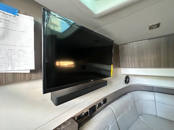 Slide: The Image of Flat-screen TV in the cabin of a 2023 Sea Ray SLX 400 OB boat. - 27