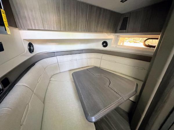Slide: The Image of Interior cabin of 2023 Sea Ray SLX 400 OB with U-shaped seating and table. - 28