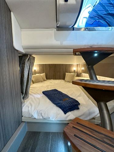 Slide: The Image of 2023 Sea Ray SLX 400 OB cabin interior with cozy bed and modern design. - 29