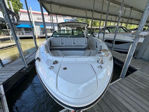 Slide: The Image of 2023 Sea Ray SLX 400 OB boat docked in a marina. - 3