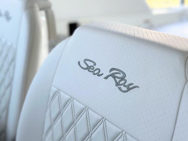 Slide: The Image of Close-up of 2023 Sea Ray SLX 400 OB white leather seat with logo. - 33