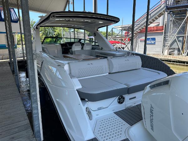 Slide: The Image of 2023 Sea Ray SLX 400 OB luxury boat docked, rear view. - 5