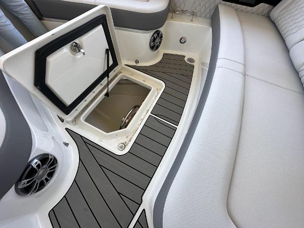 Slide: The Image of 2023 Sea Ray SLX 400 OB boat interior with open storage compartment and speakers. - 7