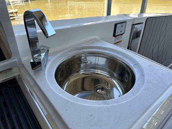 Slide: The Image of 2023 Sea Ray SLX 400 OB boat sink and faucet detail - 8