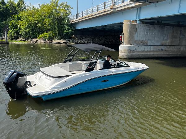 Slide: The Image of 2021 Sea Ray SPO 230 boat under a bridge on a calm river. - 0