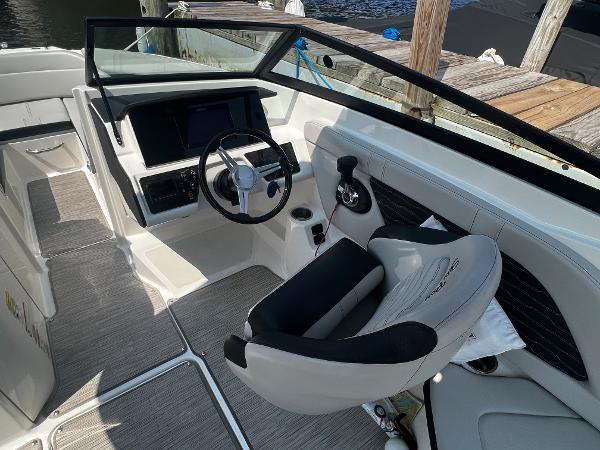 Slide: The Image of 2021 Sea Ray SPO 230 boat cockpit with steering wheel and modern controls. - 1