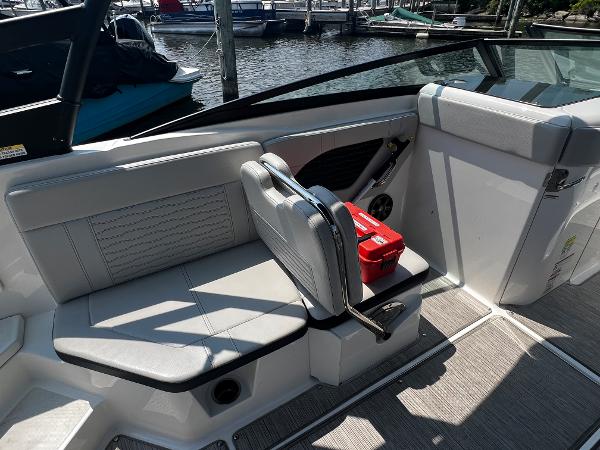 Slide: The Image of 2021 Sea Ray SPO 230 boat interior with seating and storage, docked at marina. - 3