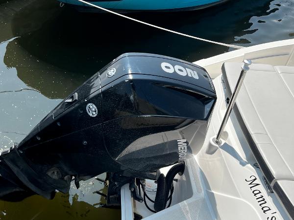Slide: The Image of 2021 Sea Ray SPO 230 boat with Mercury outboard motor docked in water. - 7