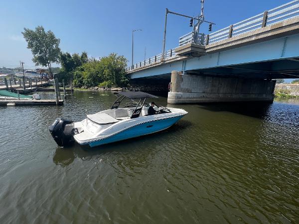 Slide: The Image of 2021 Sea Ray SPO 230 boat under a bridge on a sunny day. - 9