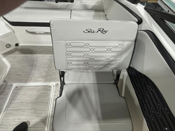 Slide: The Image of 2024 Sea Ray 210 SPX boat interior with white cushioned seating. - 10