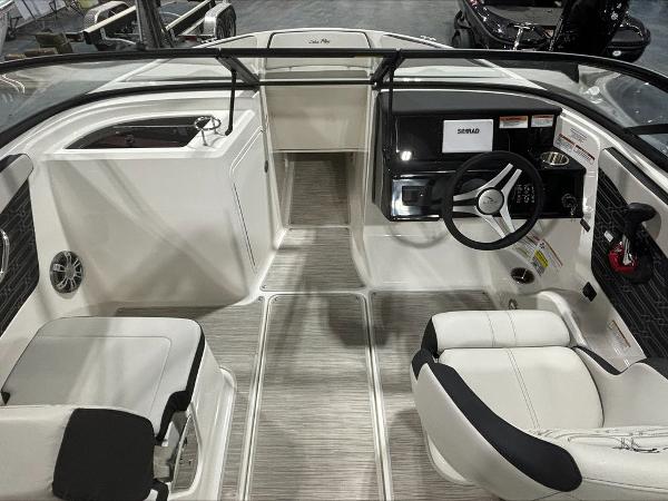 Slide: The Image of 2024 Sea Ray 210 SPX boat interior with steering wheel and seating. - 2