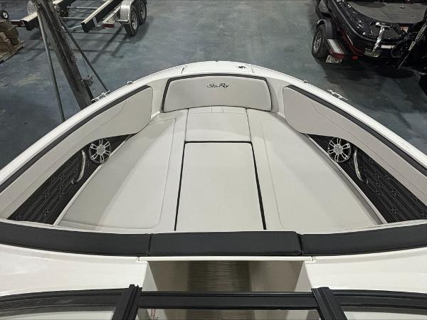 Slide: The Image of 2024 Sea Ray 210 SPX boat interior with cushioned seating and speakers. - 7