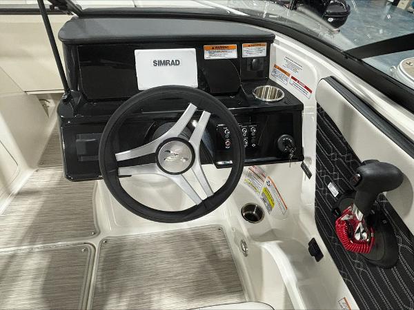 Slide: The Image of 2024 Sea Ray 210 SPX boat helm with Simrad display and steering wheel. - 8