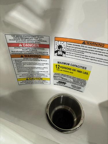 Slide: The Image of 2024 Sea Ray 210 SPX boat safety and capacity labels, maximum 12 persons or 1660 lbs. - 9