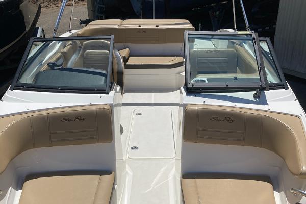 Slide: The Image of 2021 Sea Ray SPX 210 OB boat interior with tan seating and open windshield. - 10