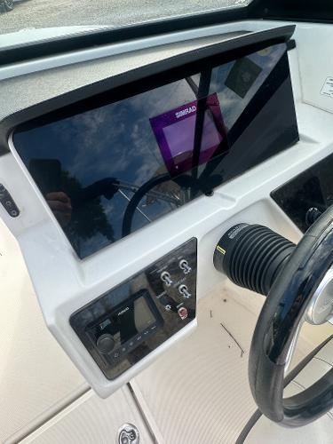 Slide: The Image of 2021 Sea Ray SPX 210 OB dashboard with steering wheel and control panel. - 11