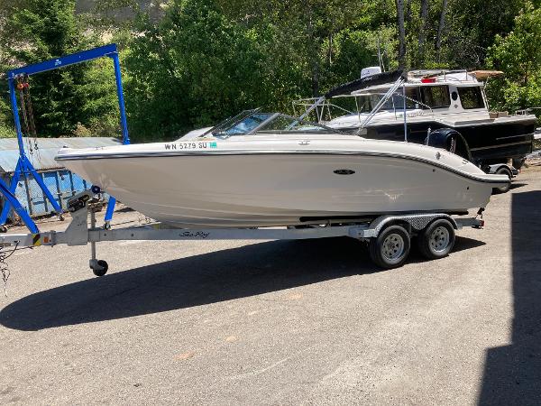 Slide: The Image of 2021 Sea Ray SPX 210 OB boat on trailer, parked outdoors. - 2