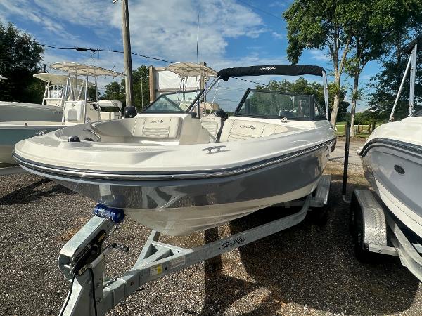 Slide: The Image of 2021 Sea Ray SPX 210 OB boat on a trailer in a marina. - 3