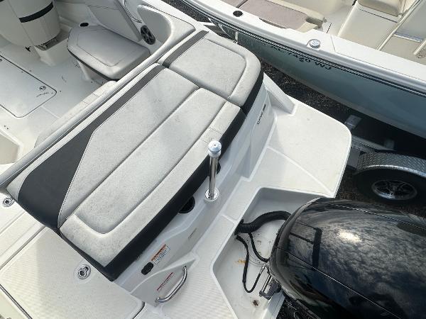 Slide: The Image of 2021 Sea Ray SPX 210 OB boat interior with cushioned seating and outboard motor. - 7