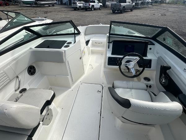 Slide: The Image of 2021 Sea Ray SPX 210 OB boat interior with steering wheel and seating. - 9
