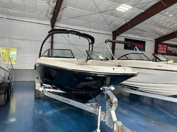 Slide: The Image of 2024 Sea Ray 210 SPX OB boat in showroom on trailer. - 0
