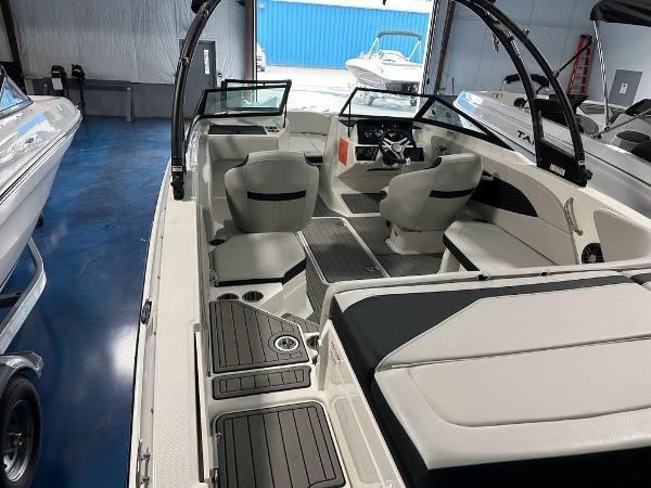 Slide: The Image of 2024 Sea Ray 210 SPX OB boat interior with seating and steering console. - 5
