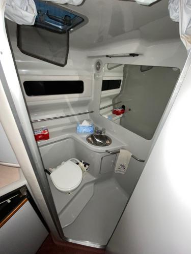 Slide: The Image of 1990 Sea Ray Sundancer boat bathroom with sink and toilet. - 4