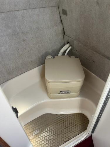 Slide: The Image of 1996 Sea Ray Sundancer boat bathroom with compact portable toilet. - 10