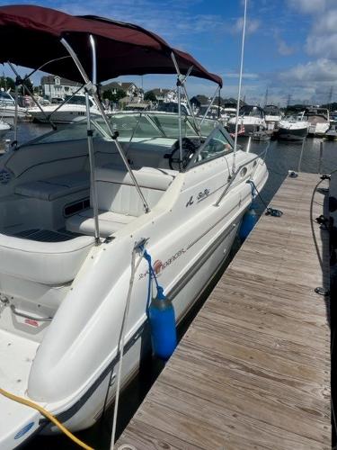 Slide: The Image of 1996 Sea Ray Sundancer docked at marina under blue sky. - 2